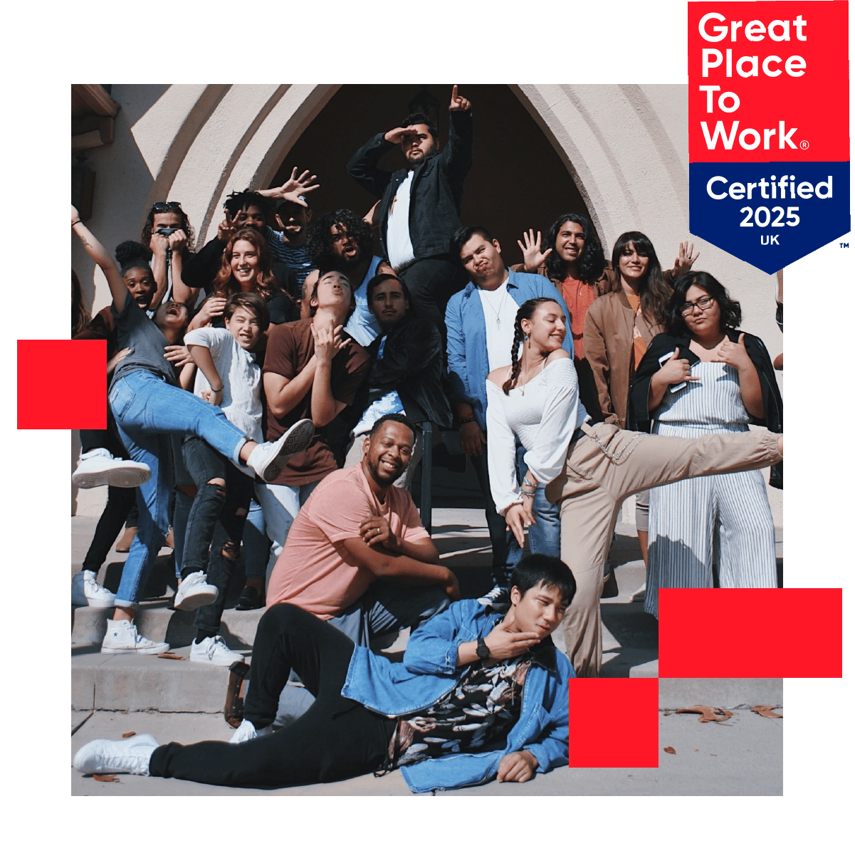 A group of employees posing for a photo looking happy and proud